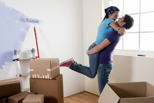 Removal team handling furniture in a Southlambeth flat